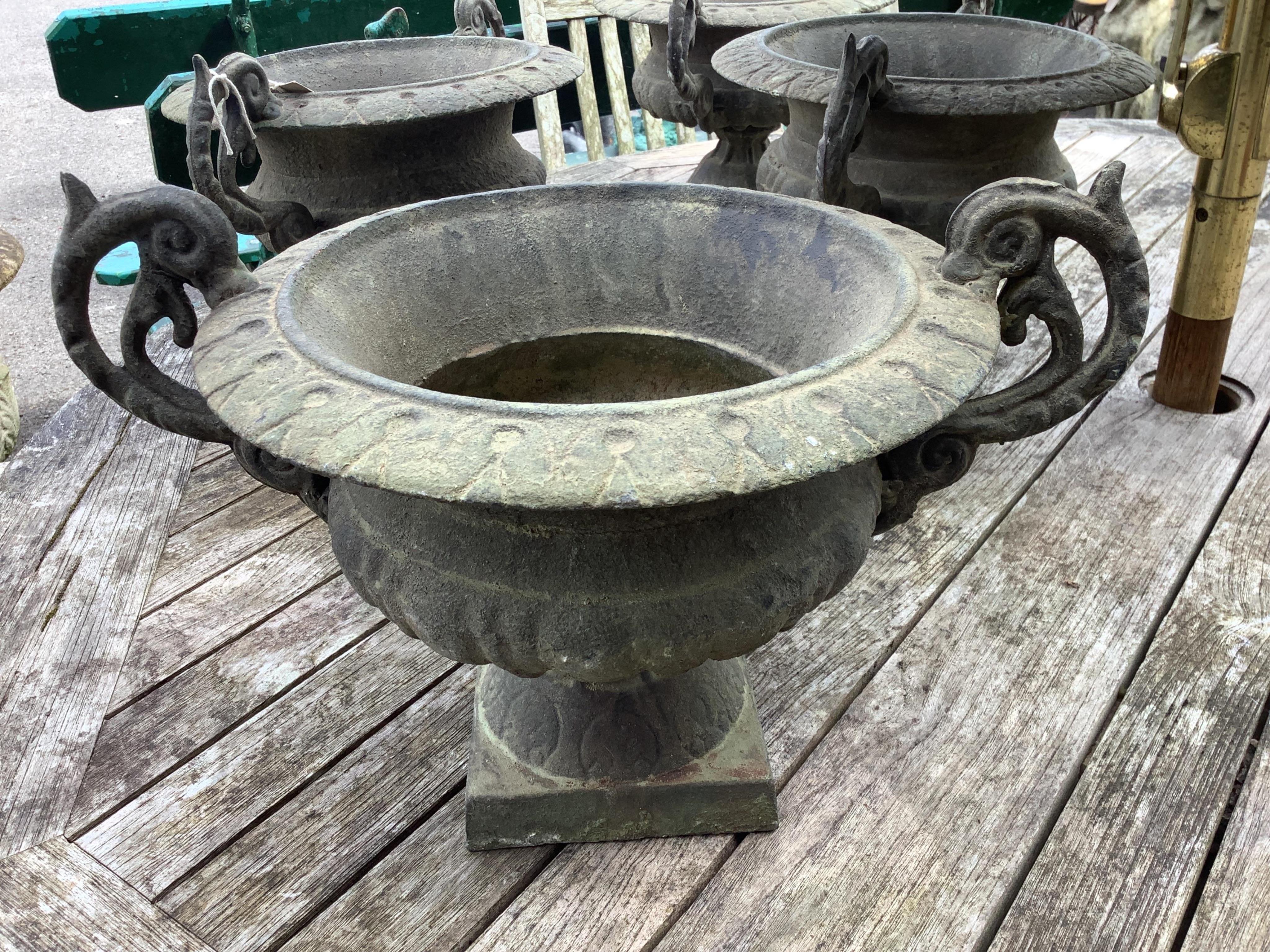 Four Victorian style cast iron campana garden planters, width 38cm, height 23cm. Condition - good